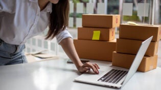 female entrepreneurs check online orders to prepare to pack the boxes