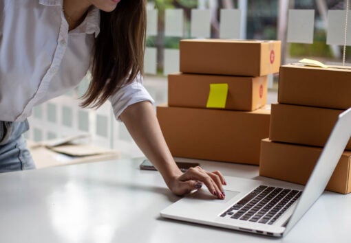 female entrepreneurs check online orders to prepare to pack the boxes