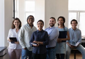 diverse office employees pose at workplace