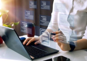 Businesswoman working on laptop with virtual screen