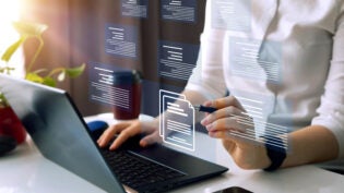 Businesswoman working on laptop with virtual screen