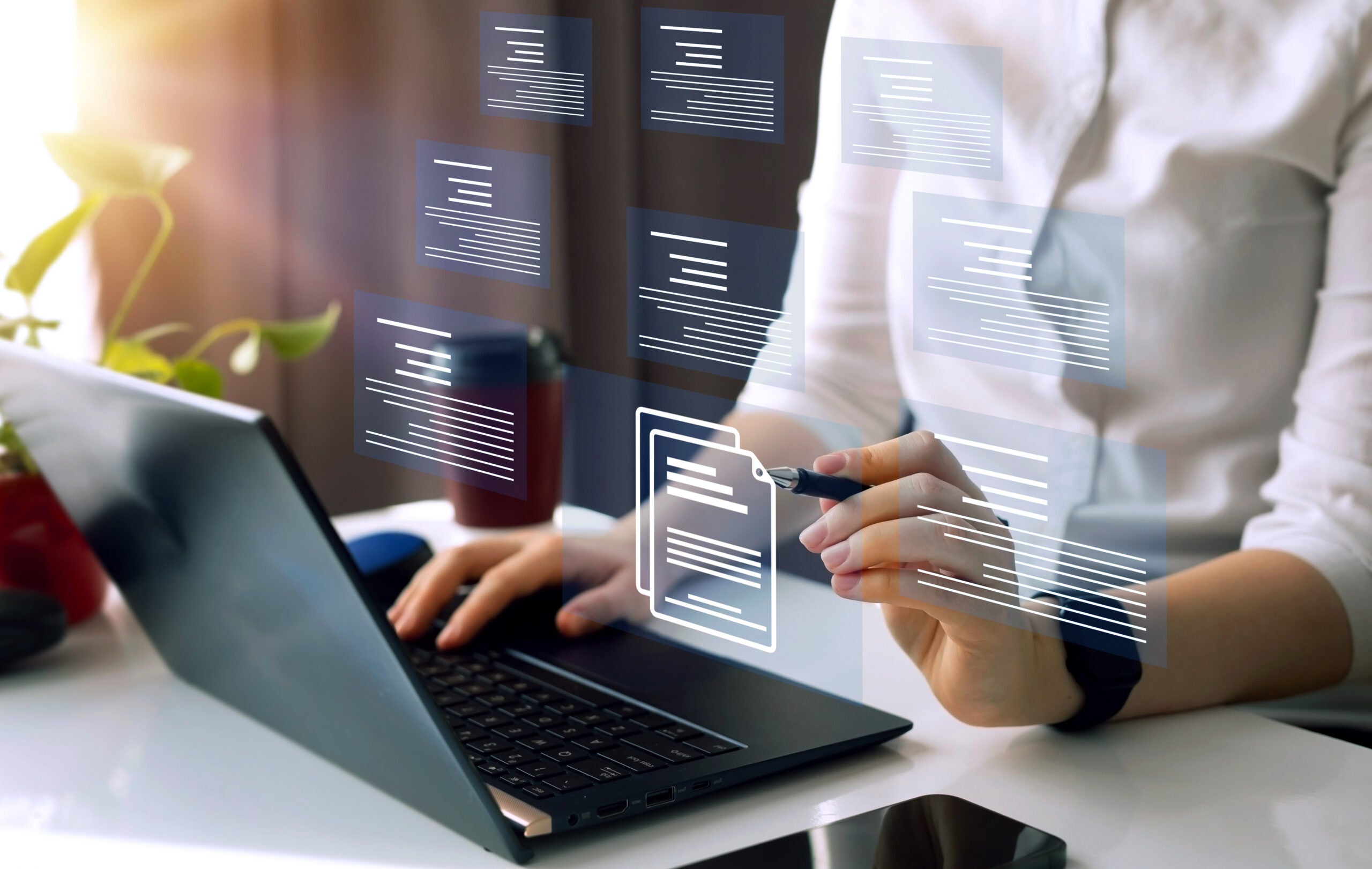 AdobeStock_583436112 Businesswoman working on laptop with virtual screen