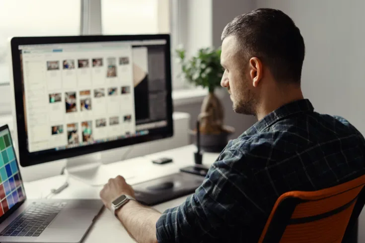 man working remotely on a computer from home office