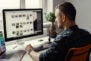 man working remotely on a computer from home office