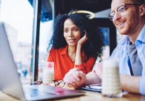 Happy diverse male and female friends watching motivation webina