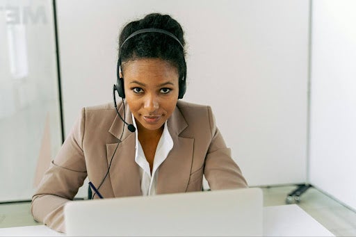 Woman at desk speaking on headset