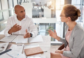 Financial advisor, man and woman in office with documents to review finance report or b2b investment contract. Strategy, planning and advisory consultant with client or investor in business meeting.