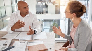 Financial advisor, man and woman in office with documents to review finance report or b2b investment contract. Strategy, planning and advisory consultant with client or investor in business meeting.
