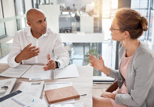Financial advisor, man and woman in office with documents to review finance report or b2b investment contract. Strategy, planning and advisory consultant with client or investor in business meeting.