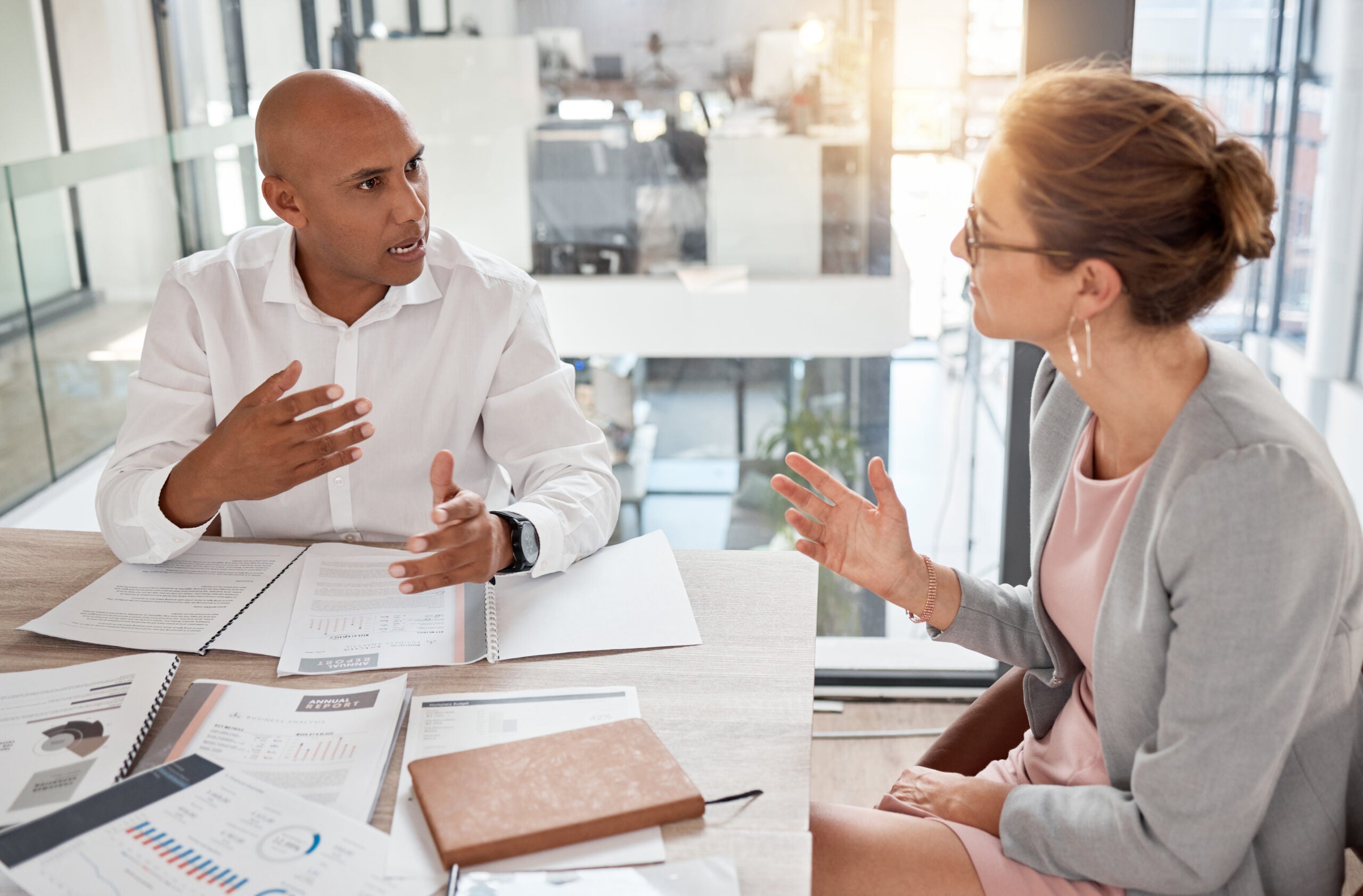 Financial advisor, man and woman in office with documents to review finance report or b2b investment contract. Strategy, planning and advisory consultant with client or investor in business meeting. Financial advisor, man and woman in office with documents to review finance report or b2b investment contract. Strategy, planning and advisory consultant with client or investor in business meeting.