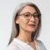 adult mature woman with long gray hair wearing eyeglasses and office clothes
