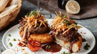 Garnished hamburger on white plate
