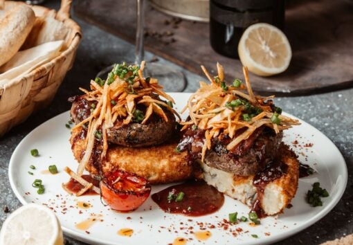 Garnished hamburger on white plate