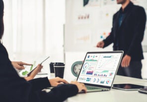 Businesswoman in business meeting using laptop computer proficiently at office for marketing data analysis . Corporate business team collaboration concept .