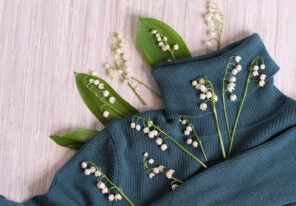 flowers, and clothes on a wooden background.