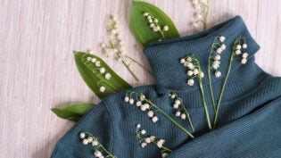 flowers, and clothes on a wooden background.
