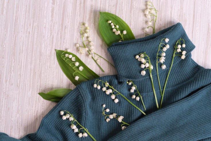 flowers, and clothes on a wooden background.