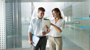 Corporate business people using digital tablet in modern office