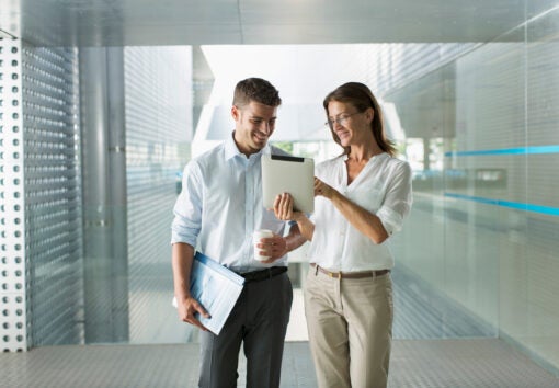 Corporate business people using digital tablet in modern office